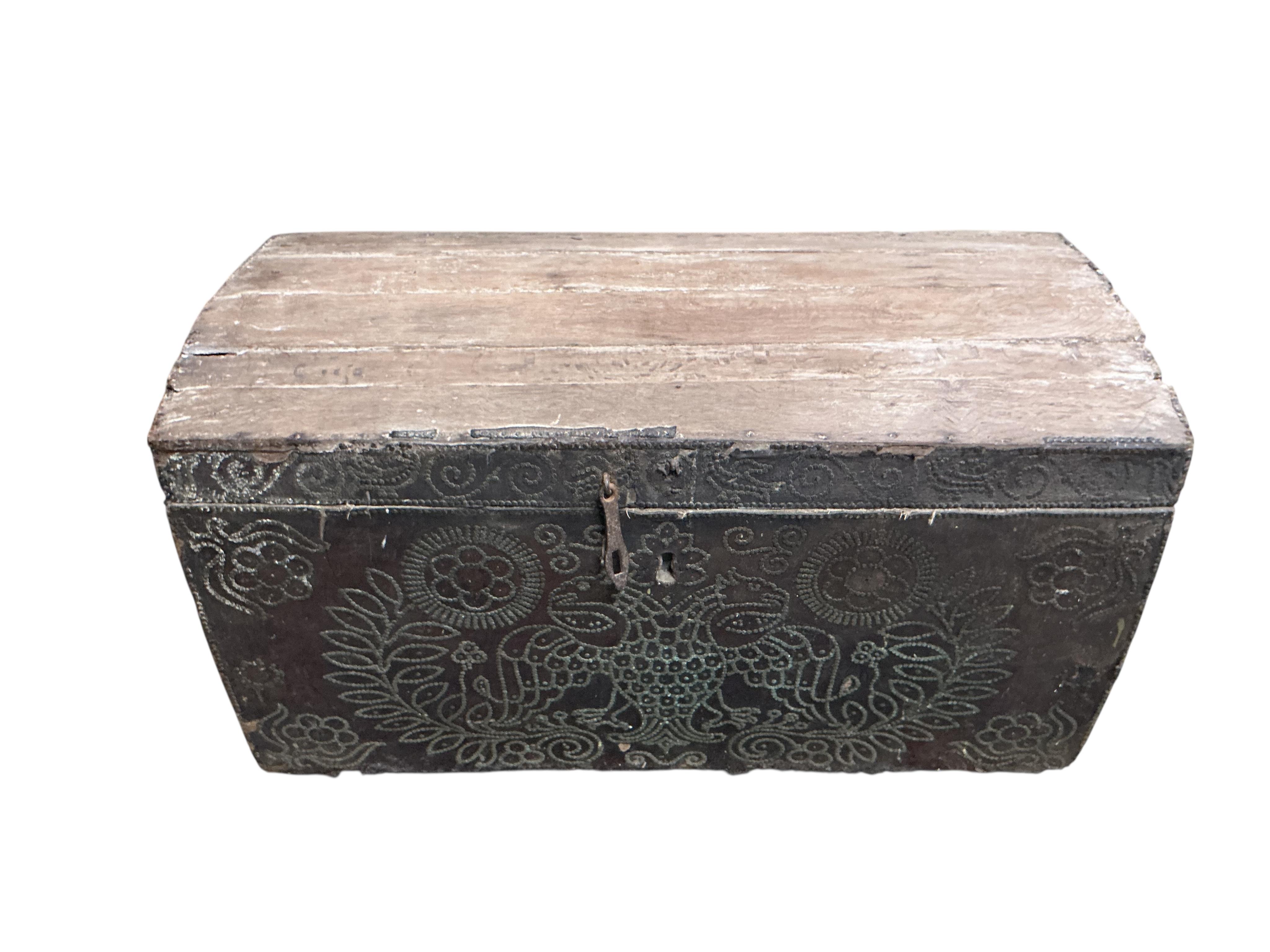 An 18th century oak domed trunk the front with the remnants of studded leather work, width 118cm, depth 53cm, height 65cm